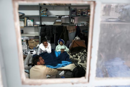 Rescued migrants wait in the coastguard’s office in Rhodes.
