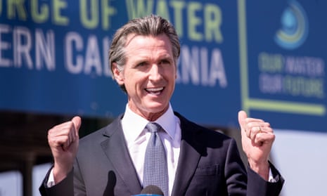 Gavin newsom in front of sign about water that is not fully legible in image