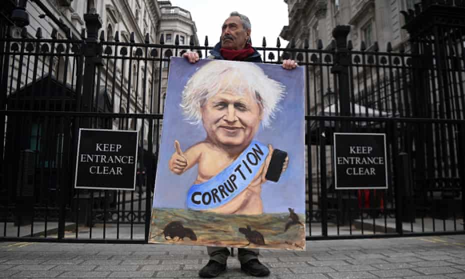 Kaya Mar with his painting of Boris Johnson outside Downing Street in London.