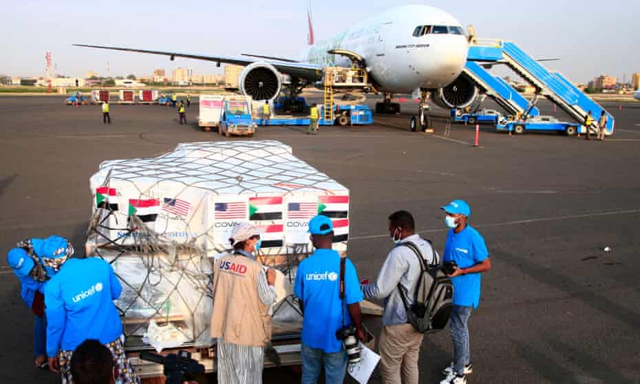 Aid workers at Khartoum airport in Sudan check a shipment of coronavirus jabs sent by the Covax vaccine-sharing scheme