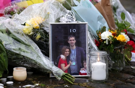 A framed photograph of UK Labour MP Jo Cox and her husband Brendan outside 10 Downing Street in London sits beside floral tributes to Jo, who was murdered on 16 June 2016.