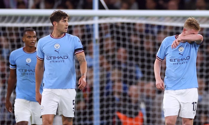Manchester City's John Stones (second from the left) and Kevin De Bruyne looked depressed after Borussia Dortmund's Judd Bellingham opened the scoring.