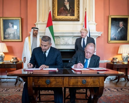 Boris Johnson and Khaldoon al-Mubarak at a signing of papers
