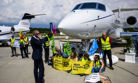 Environmental activists from Stay Grounded and Greenpeace handcuffed to an aircraft during the European Business Aviation Convention and Exhibition (EBACE) at Geneva airport.