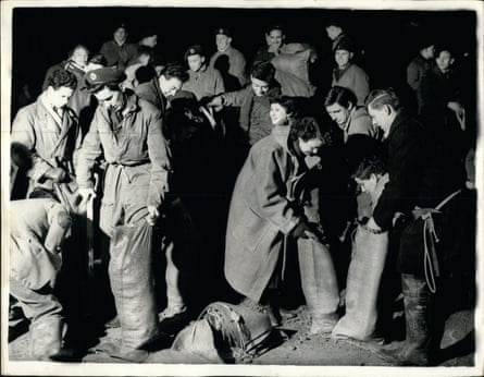 Students in Kingston-on-Thames fill sandbags at 2am on 2 February 1953 as the Thames bursts its banks.