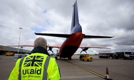 Staff from UK Aid watch as cargo is loaded on to an aircraft at East Midlands Airport as part of the UK Government’s humanitarian response to the crisis in Iraq