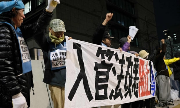 People stage a rally in Tokyo against a bill to allow more foreign workers in front of parliament.