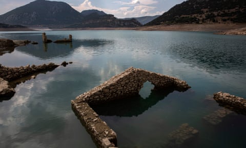 Stone buildings sticking out from the water