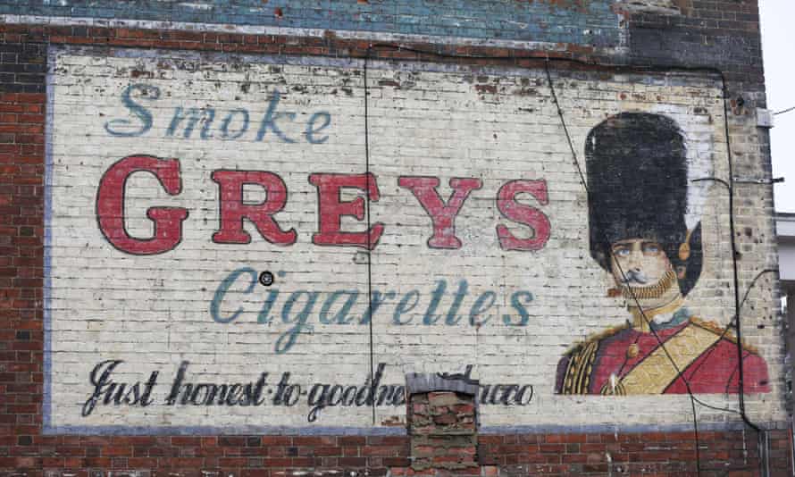 The Greys Cigarettes advert that sits below a Bovril ghost sign on a building in Bedford.