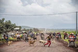 People take to the road with as many possessions as they can carry, near Kibumba.