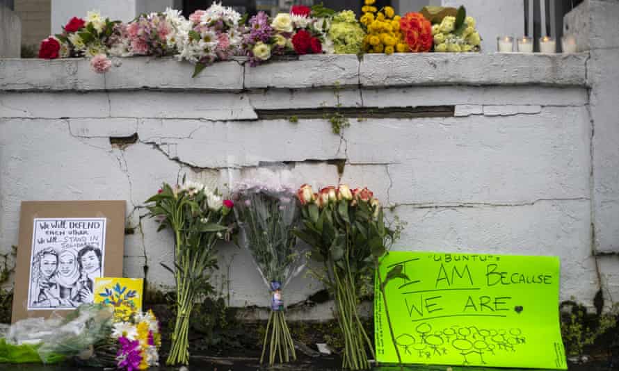 Flowers and signs are displayed at a makeshift memorial outside of the Gold Spa in Atlanta.