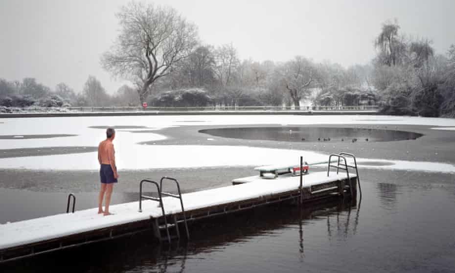 The men only Highgate Ponds, also known as Hampstead Ponds, in North London is a favourite spot for an early morning dip. As Britain is seized by the Big Freeze a few stalwarts go swimming in sub zero temperatures as the snow and ice turns Hampstead Heath in a winter wonderland. Swimming in freezing water can be dangerous to the uninitiated so people wishing to swim in the ponds during the winter are advised to acclimatise themselves to outdoor swimming. Advice from the Amateur Swimming Association is to start swimming outdoors in the summer and continue into winter preferably three or four times a week for short periods. Dangers are said to include numb freezing cold injury, hypothermia and sudden immersion syndrome (SIS). Photo by Michael Walter/Troika swim swimmers swimmer ice extreme sports