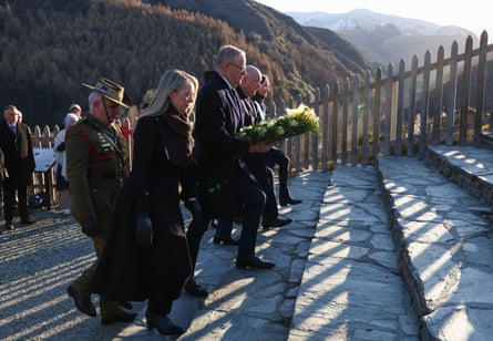 The two leaders carry wreaths to a memorial during a wreath laying ceremony at Arrowtown War Memorial Park on Sunday.