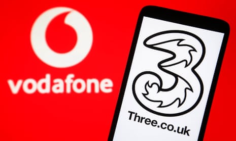 Vodafone logo on PC screen and Three UK logo on a smartphone