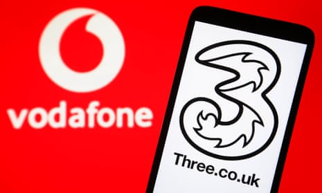 Three logo on a smartphone with a Vodafone logo on a PC screen.