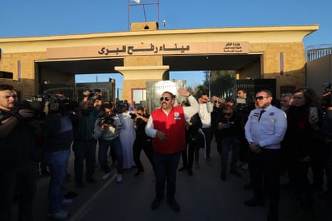 An Egyptian Red Crescent humanitarian society representative speaks to the media and the UN security council ambassadors in front of Egypt's eastern border with the Gaza Strip in Rafah