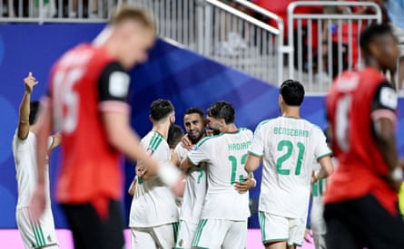 Riyad Mahrez gets mobbed after scoring Algeria’s second.