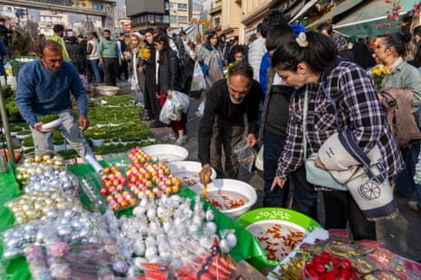 People shop for goldfish at a market ahead of Nowruz celebrations on 19 March 2026 in Tehran, Iran.