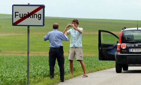 Tourists taking pictures of the road sign of the village of Fucking. Some visitor have reportedly even stolen the signposts.