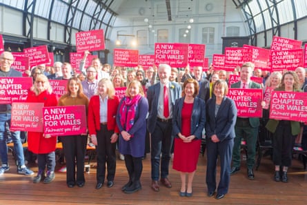 Eluned Morgan with colleagues and supporters who are holding placards that say ‘A new chapter for Wales’