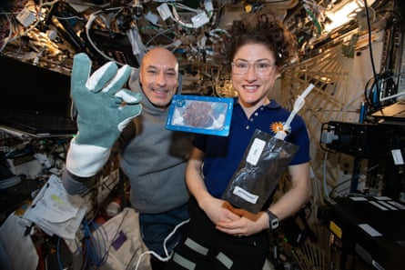 ISS commander Luca Parmitano and astronaut Christina Koch with milk and cookies on board the International Space Station (ISS).