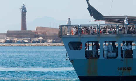 The Italian navy ship Orione enters the Spanish port of Valencia on 17 June carrying 630 migrants from north Africa.