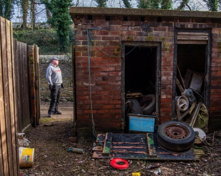 Photograph taken from the house’s backyard looking out at Gilbert standing in the back lane