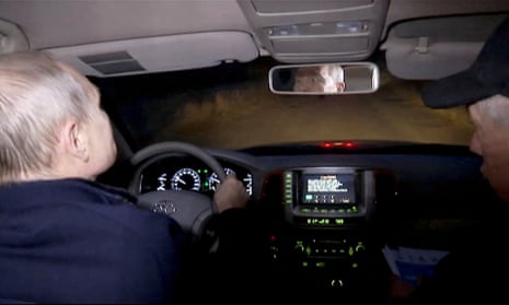 Russian president, Vladimir Putin, drives as he visits Mariupol, Russian-controlled Ukraine, in this still image taken from a handout video.