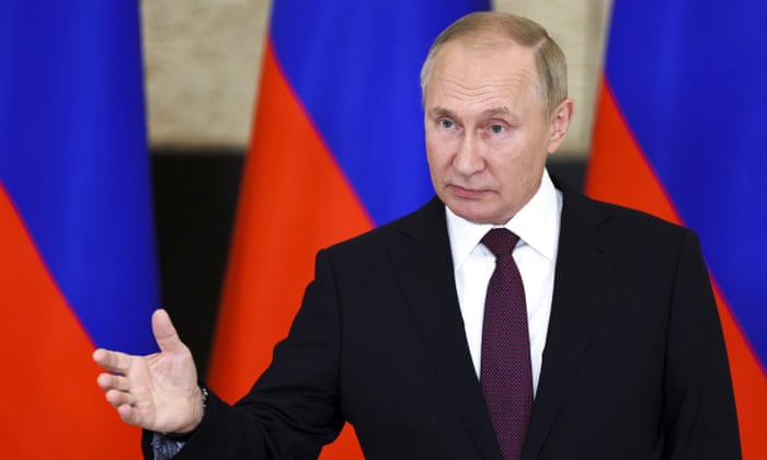 Vladimir Putin gestures to reporters after the summit in Uzbekistan
