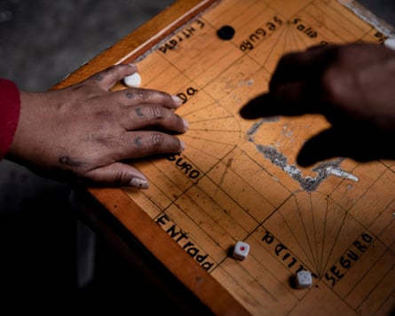 Two hands on a game board with dice on it
