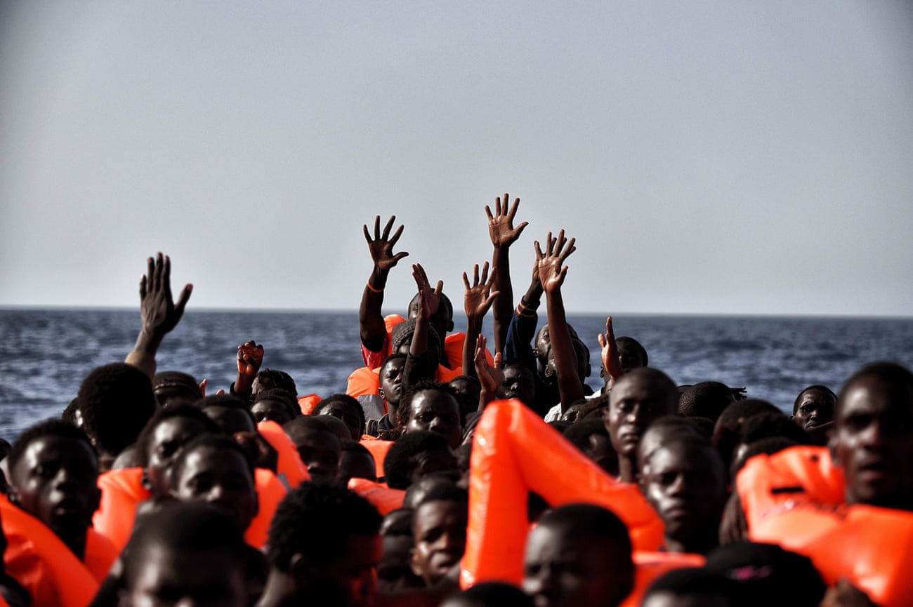 People wait to be rescued as they drift in the Mediterranean off the coast of Libya