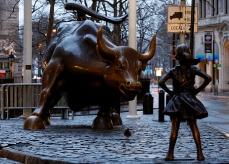 A statue of a girl facing the Wall St Bull is seen, as part of a campaign by U.S. fund manager State Street to push companies to put women on their boards, in the financial district in New York, U.S., March 7, 2017. REUTERS/Brendan McDermid