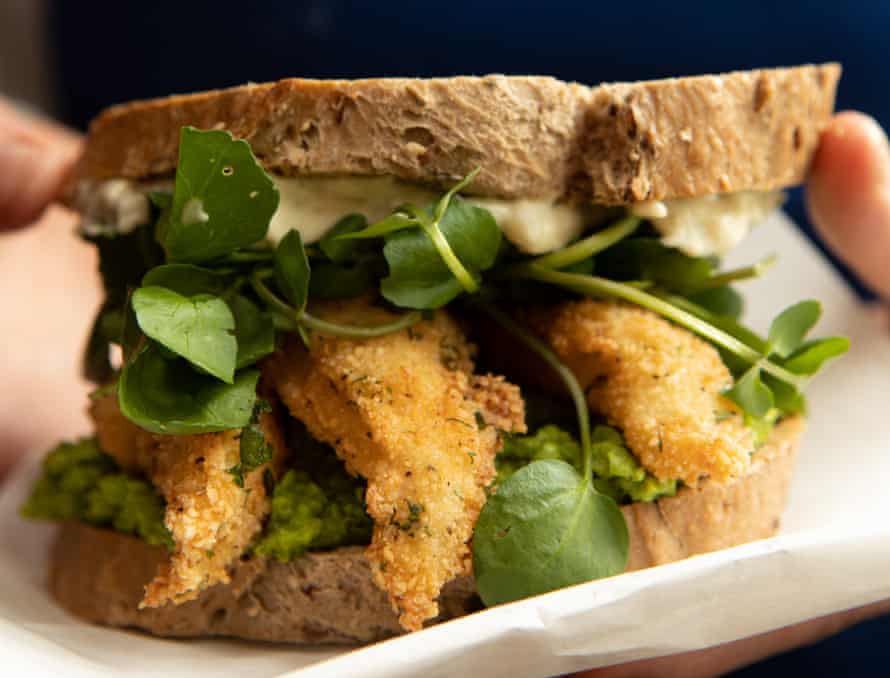 Fish finger sandwich with minty pea puree and tartare sauce.