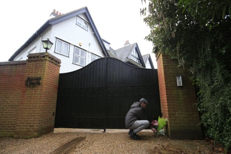A local well-wisher leaves flowers outside the home of Sir Terry Wogan in Taplow, Buckinghamshire