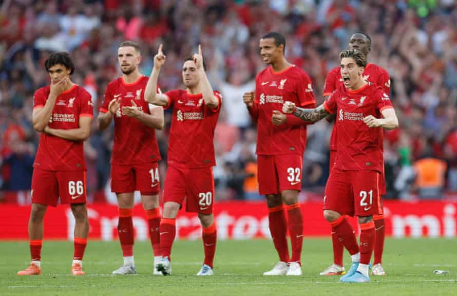 Liverpool players react after Roberto Firmino scores a penalty during the shoot-out.