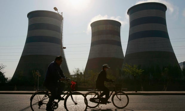 Local residents cycle past chimneys at a steel factory in Shenyang, in northeast China’s Liaoning province.