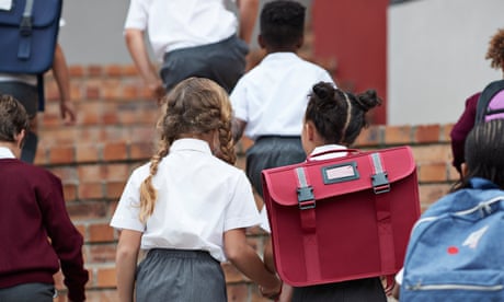 School children walking on staircase to school building