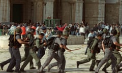 Israeli troops run as clashes erupt outside the Al-Aqsa mosque compound in Jerusalem's Old City 28 September 2000