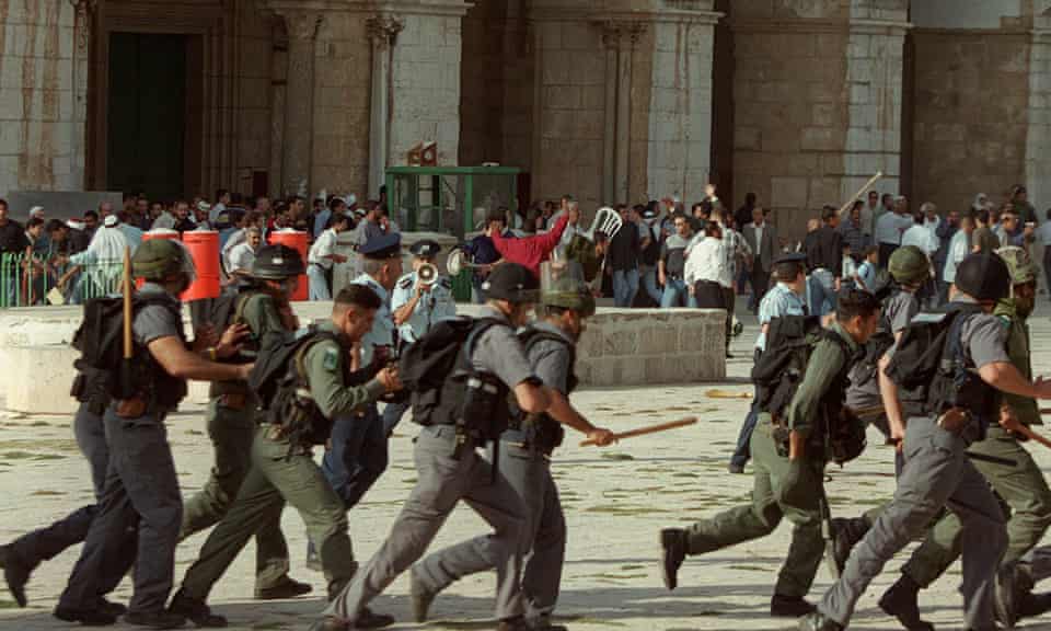 Israeli troops run as clashes erupt outside the al-Aqsa mosque compound in Jerusalem, September 2000.