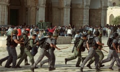 Israeli troops run as clashes erupt outside the al-Aqsa mosque compound in Jerusalem, September 2000. Photograph: Awad Awad/AFP/Getty Images