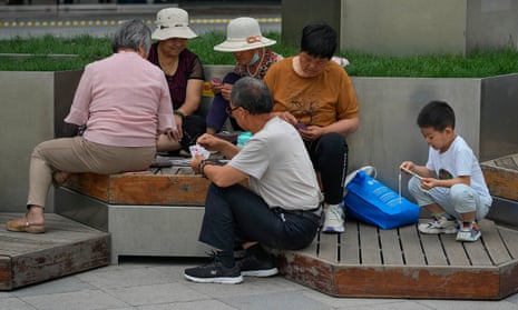 Group Of Young Asian People Sitting And Addicted To Playing Mobile