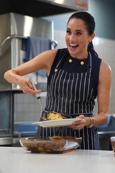 The Duchess of Sussex serves lunch to a resident during a visit to McAuley Community Services for Women, a women’s homeless and family violence shelter in Footscray, in Melbourne
