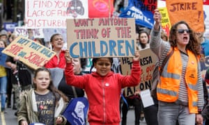Child carrying a placard reading ‘Won’t anyone think of the children’ during a protest about education funding cuts