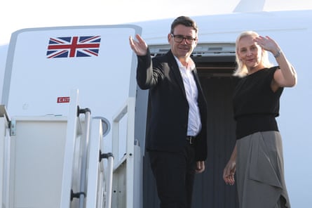 Van Heel and Burnham wave from the door to a plane at the top of aircraft stories