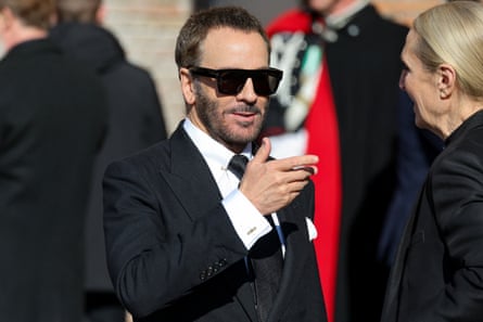 Tom Ford in black sunglasses and suit, with white shirt