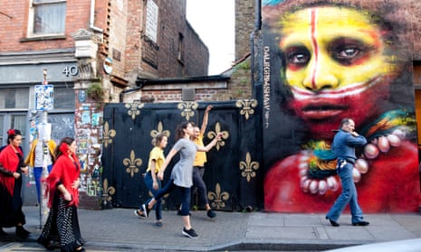 Dancers who are part of Melanie Manchot’s commission for Art Night 2017 pass a mural by Dale Grimshaw in London. 