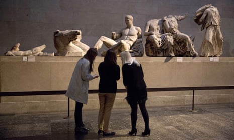 Visitors to the British Museum look at statues  from the east pediment of the Parthenon.