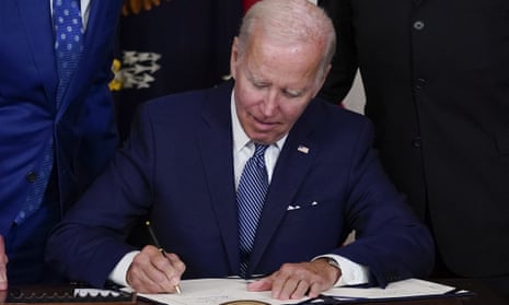 Joe Biden signs the Democrats' landmark climate change and healthcare bill at the White House last month.
