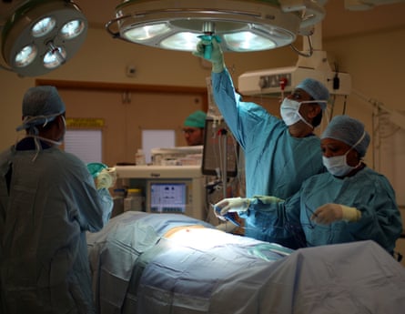 A surgical team prepare a patient before an operation at Milton Keynes university hospital