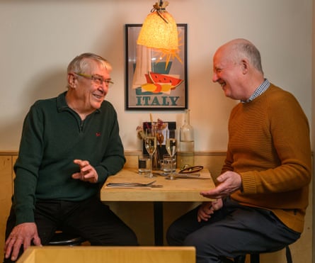 Two men facing each other across a restaurant table